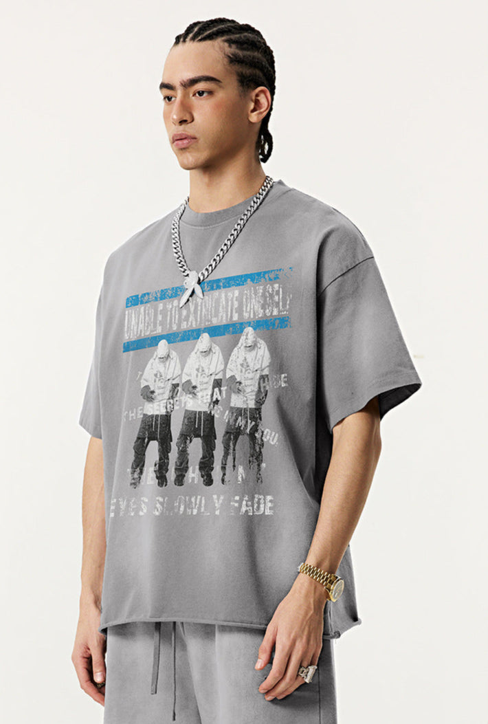 Model in grey Eyes Fade tee facing left, showing front graphic and casual fit.