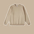 Beige crewneck sweatshirt with ribbed collar, cuffs and hem displayed against matching beige background
