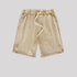 A pair of beige washed drawstring shorts featuring an elastic waistband, white drawstrings, and side pockets