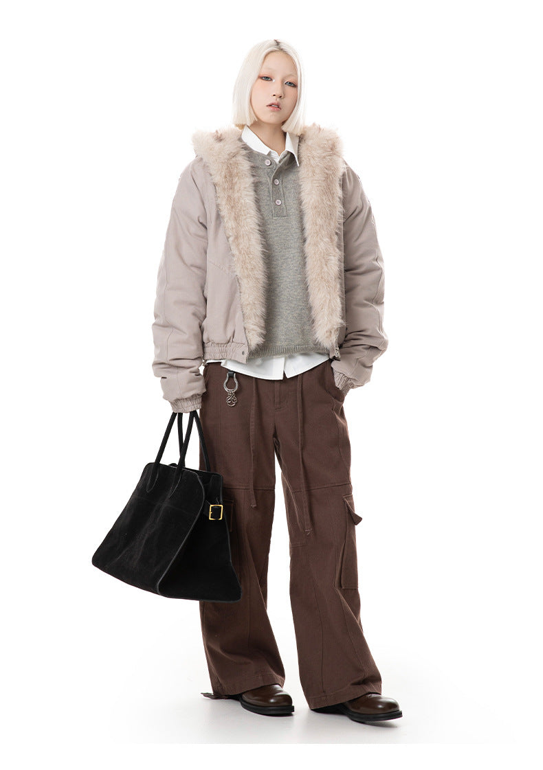 Full-body view of taupe faux fur hood bomber jacket styled over a grey sweater and brown cargo pants.