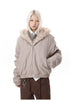 Medium close-up of taupe winter bomber jacket highlighting front zip closure and hand pocket.