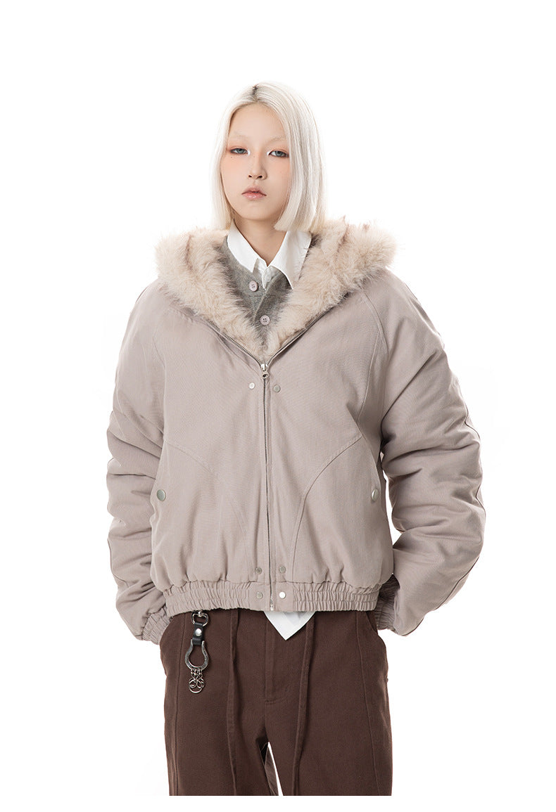 Front view of zipped taupe winter jacket showing structured ribbed hem and side pockets.