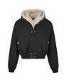 Studio flat-lay product view of the black faux fur hood bomber jacket.