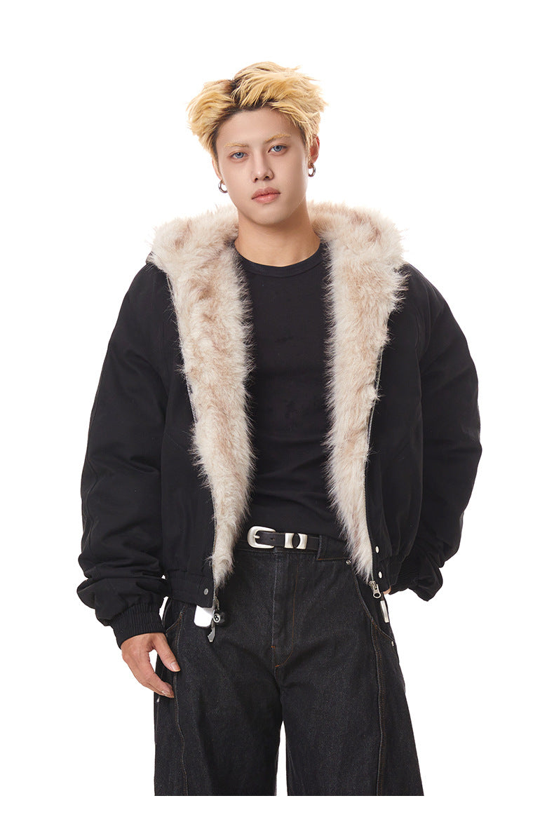 Medium close-up of black heavy bomber jacket highlighting wide plush faux fur collar lining.