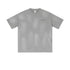 Light gray oversized t-shirt with chest pocket and subtle distressed details on white background