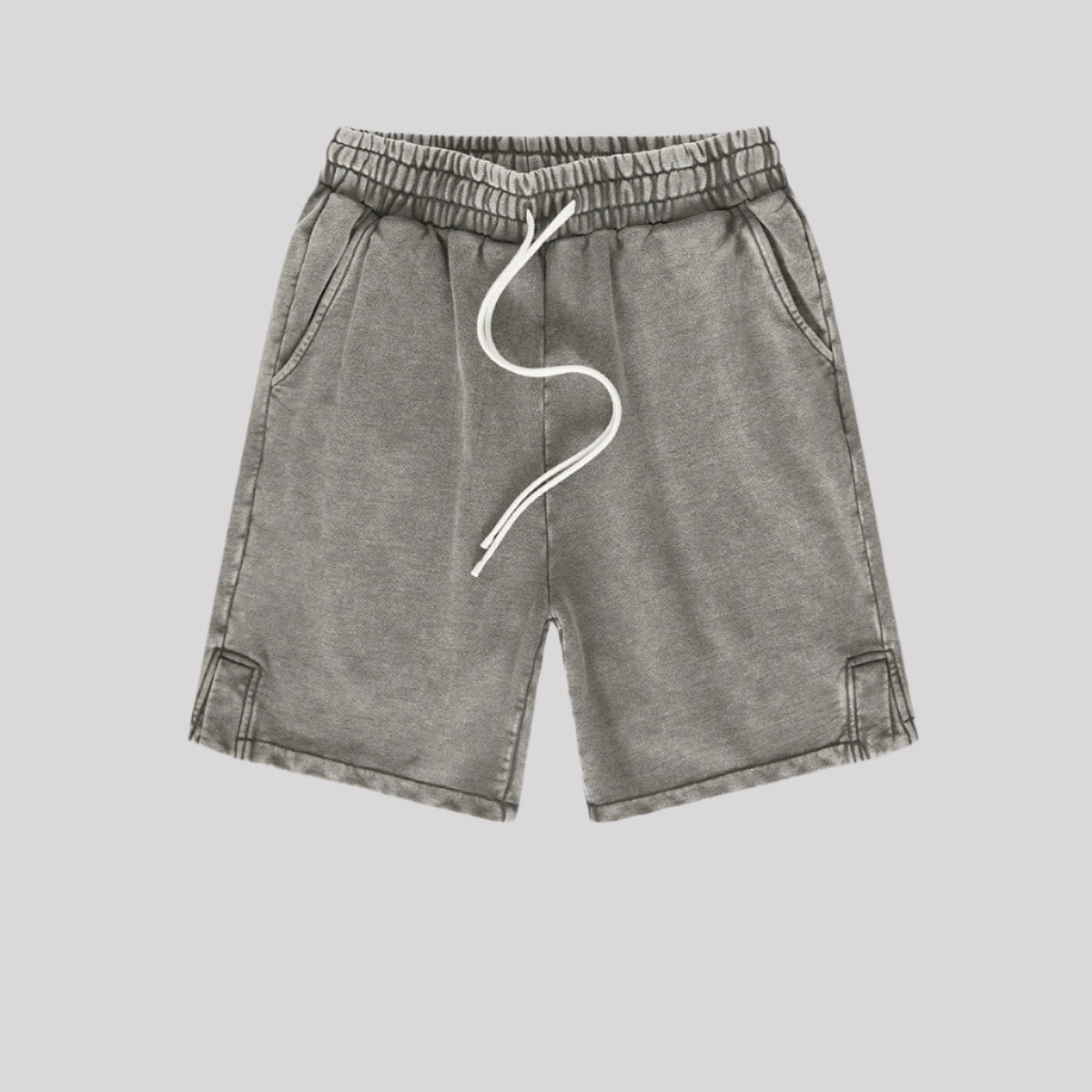 A pair of gray washed drawstring shorts with an elastic waistband, side pockets, and stitched hem details
