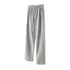 Full-length light grey wide-leg tracksuit pants with drawstring waist and side detail on white background
