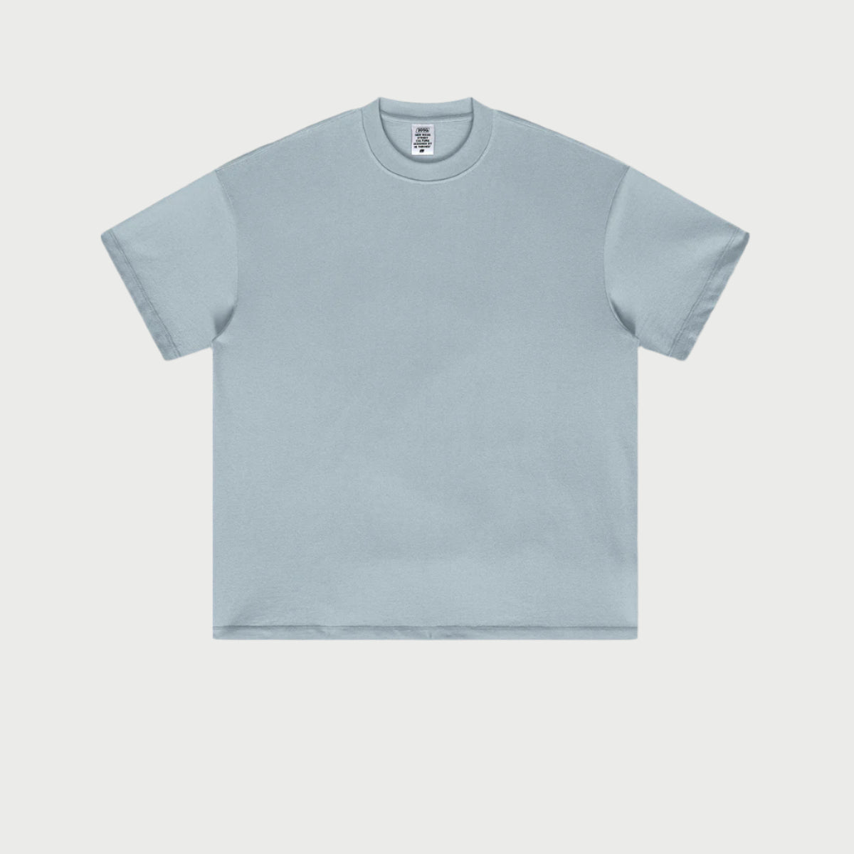 Pale blue oversized t-shirt displayed flat against light gray background with crew neck and short sleeves