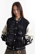Three-quarter front view showing chest embroidery, ribbed collar, and welt pockets