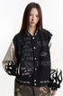 Close front view of the charcoal varsity jacket with cream sleeves and mixed embroidery