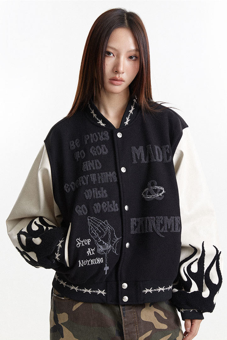 Close front view of the charcoal varsity jacket with cream sleeves and mixed embroidery