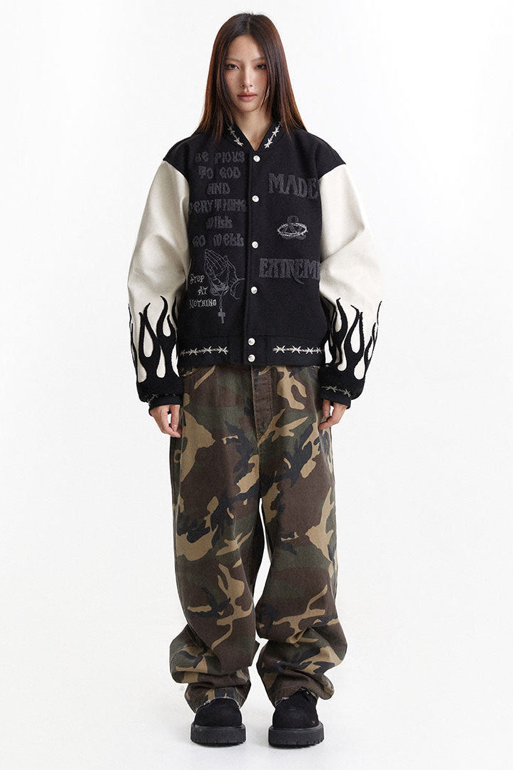 Full-length styling of the embroidered varsity jacket with wide camouflage pants