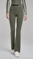 Woman wearing army green flare leggings with white side stripes.