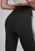 Close-up of black high-waisted leggings with side stripes, back view.