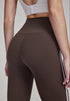 Woman wearing brown high-waisted flare leggings, back view.