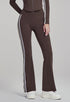 Woman wearing brown high-waisted flare leggings, front view.
