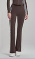Woman modeling chestnut brown flare leggings with side stripes, hands relaxed.