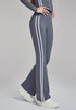 Woman modeling sea rock grey flare leggings with white stripes in right side view.