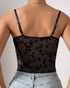 Back view of sheer black mesh corset top with floral velvet embroidery and thin straps.
