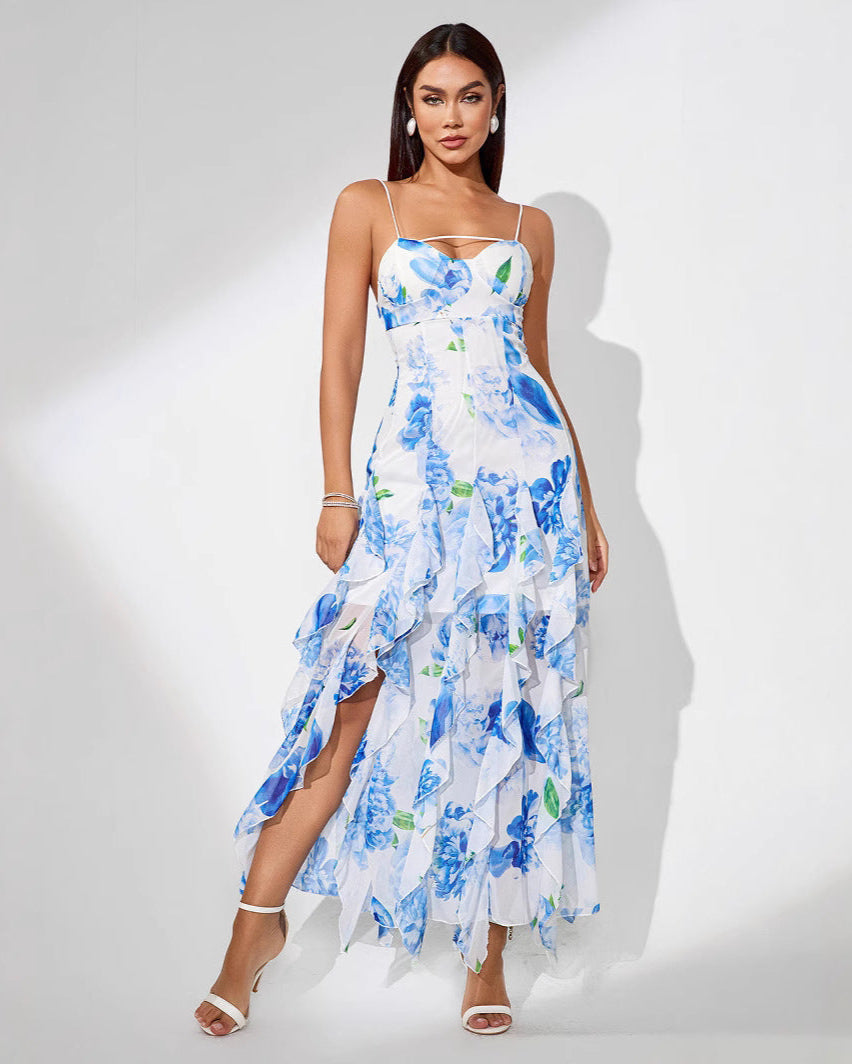 Woman wearing a blue floral ruffle slit dress on a white background