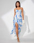 Woman wearing a blue floral slit dress on a white background