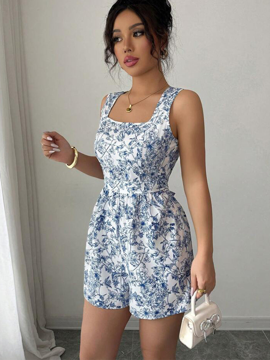 Side view of belted floral summer romper with blue and white print