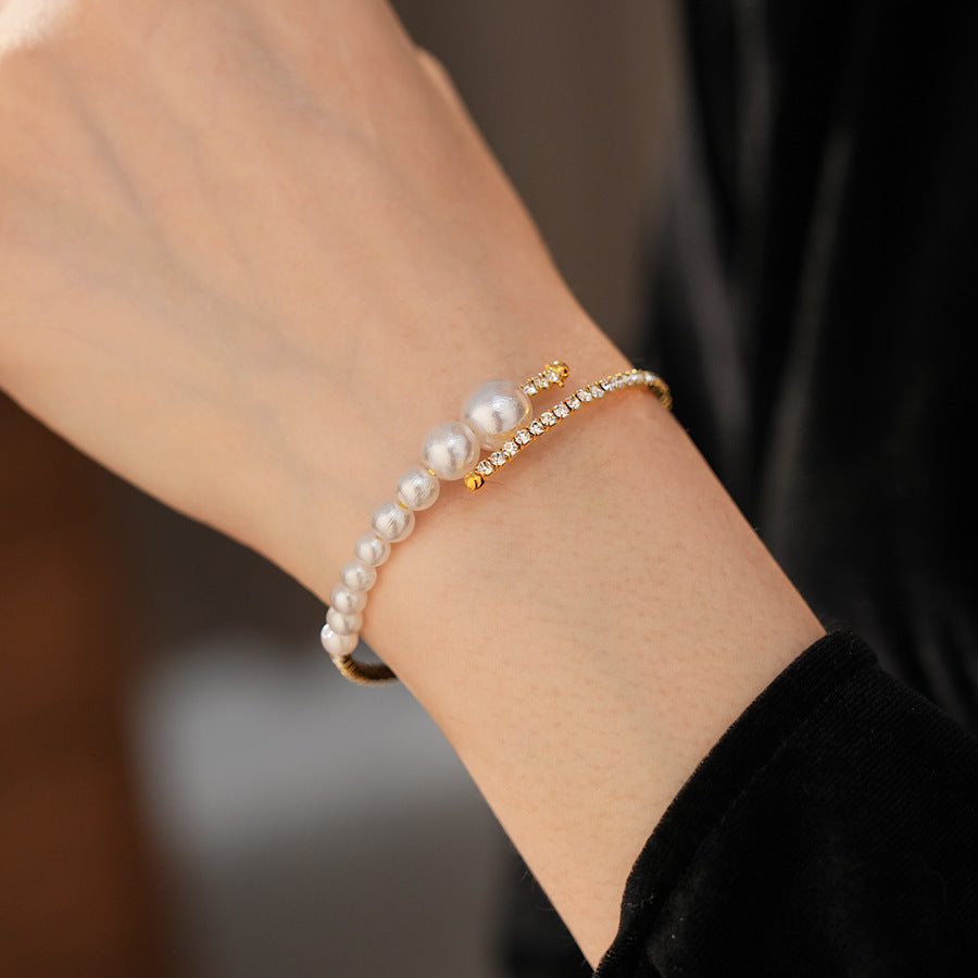 side-angle view of the gold pearl cuff bracelet worn on the wrist
