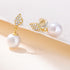 Gold pearl drop earrings with diamond-shaped stud, 925 posts.