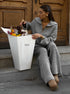 Woman holding shopping bag wearing gray half zip sweater 2 piece set
