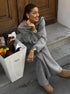 Sitting pose in gray half zip sweater 2 piece set with wide pants