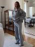 Gray knit 2 piece set with half zip sweater and wide leg pants in living room