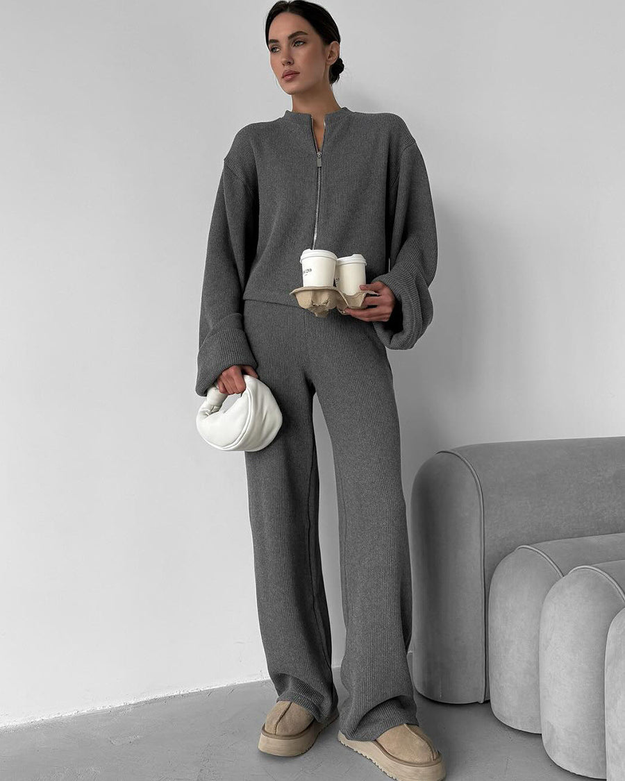 Woman wearing gray knit lounge set with zip jacket and wide leg pants