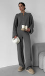 Woman wearing gray knit lounge set with zip jacket and wide leg pants