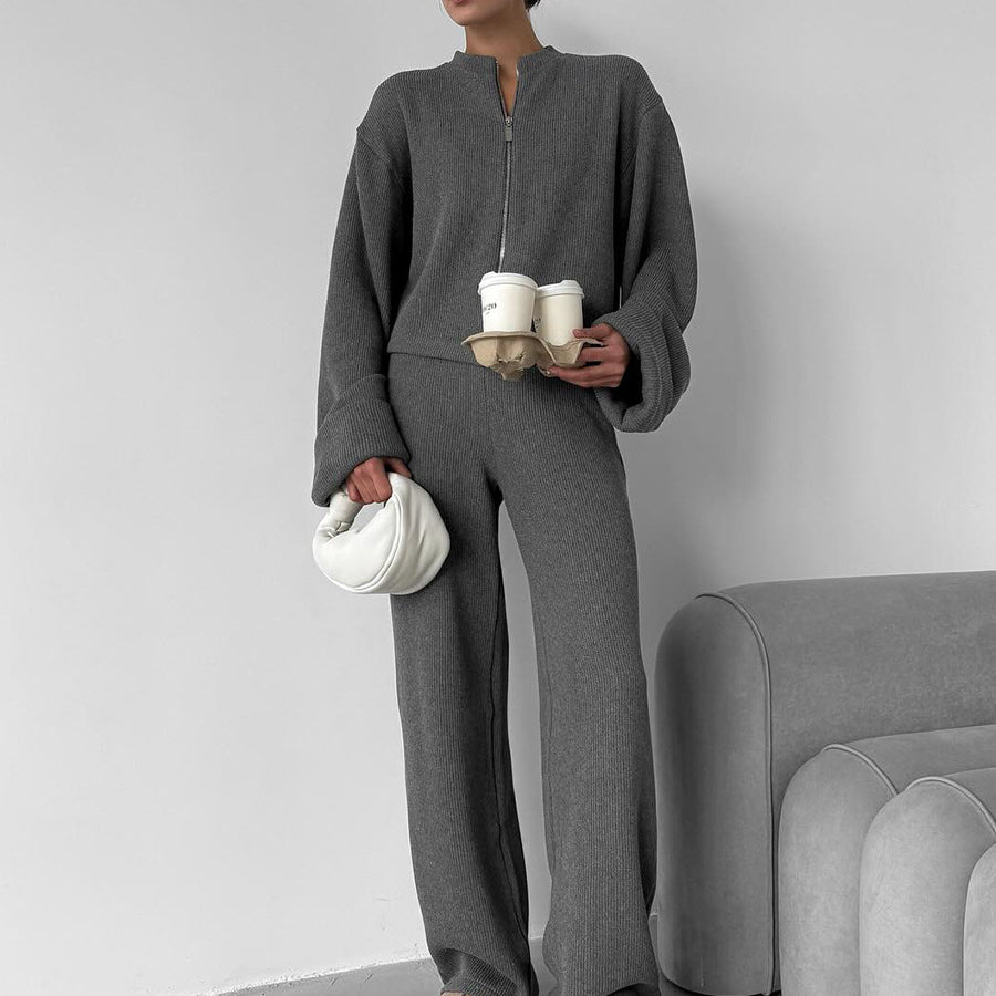 Woman wearing gray knit lounge set with zip jacket and wide leg pants