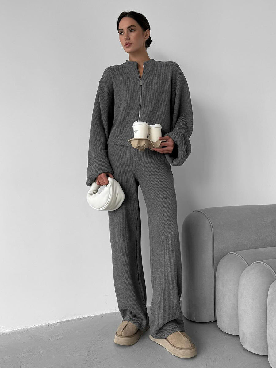 Woman wearing gray knit lounge set with zip jacket and wide leg pants