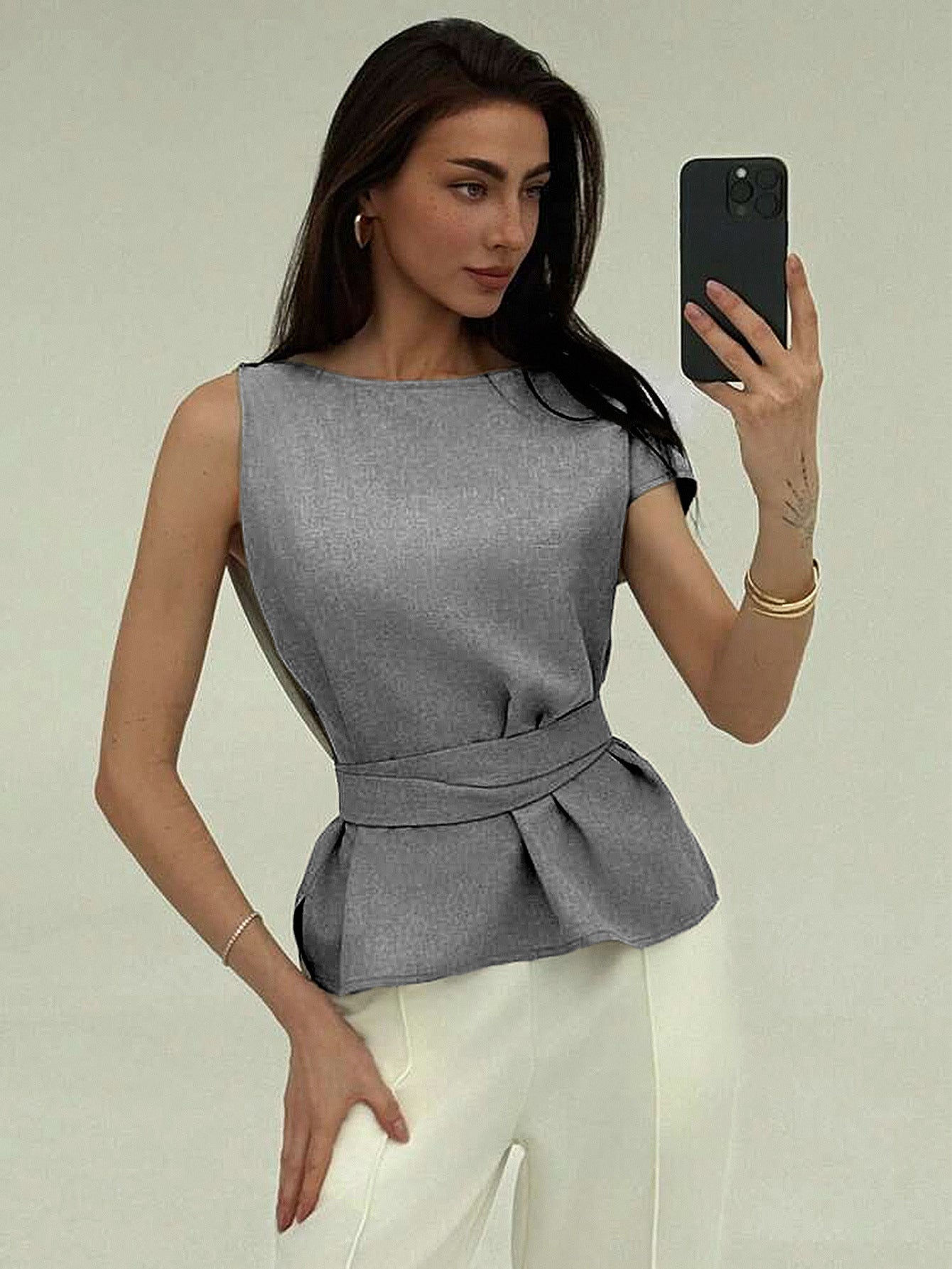 Gray sleeveless summer top with belt detail styled for office look