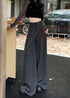 Model wearing gray flowy drawstring trousers styled with cropped ribbed sweater and beanie.