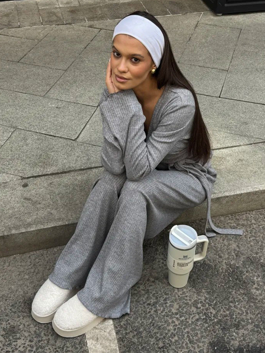 woman sitting on pavement wearing gray ribbed lounge set with white headband