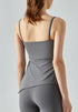 Back of gray yoga tank top with smooth finish and built-in bra design.