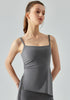 Portrait view of woman wearing gray cooling yoga tank top with square neckline.