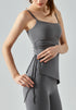 Woman wearing gray cooling tank top showing side ruching and fitted shape.