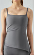 Woman in titanium gray cooling tank top featuring side ruching.