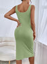 Back angle of green ribbed bodycon midi dress with sleeveless U-neckline.