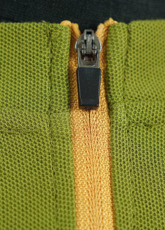 Close-up yellow zipper on green retro contrast long sleeve t-shirt