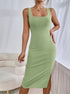 Green ribbed knit midi dress highlighting side slit and sculpting bodycon fit.