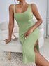 Green bodycon midi dress with rib texture and high side slit in stretchy knit.