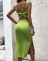 Back view of green square-neck bodycon midi dress with crossover straps and slim fit.