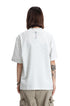 Rear view of a model in a heather light grey crewneck t-shirt showing a small back key print.