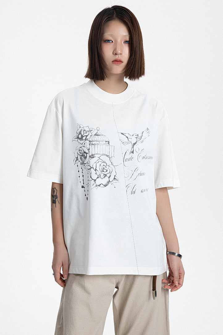 Front view of a model wearing a white cotton blend graphic t-shirt with delicate rose print.