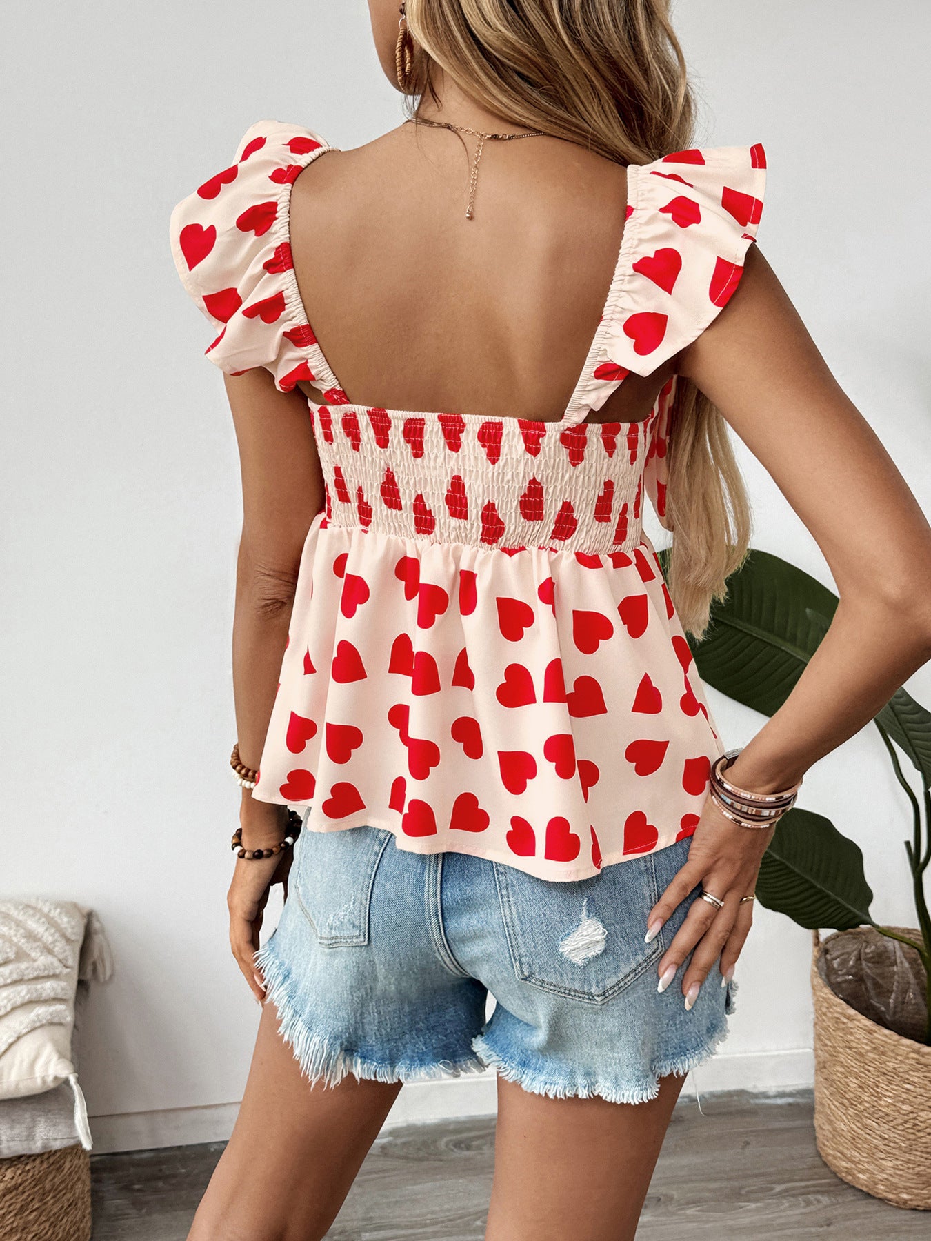 Back view of heart print bow top with ruffle straps